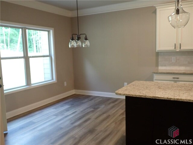 41 Hometown Ct, Jefferson, GA 30549 - unfurnished dining area featuring light wood-type flooring, a healthy amount of sunlight, crown molding, and baseboards