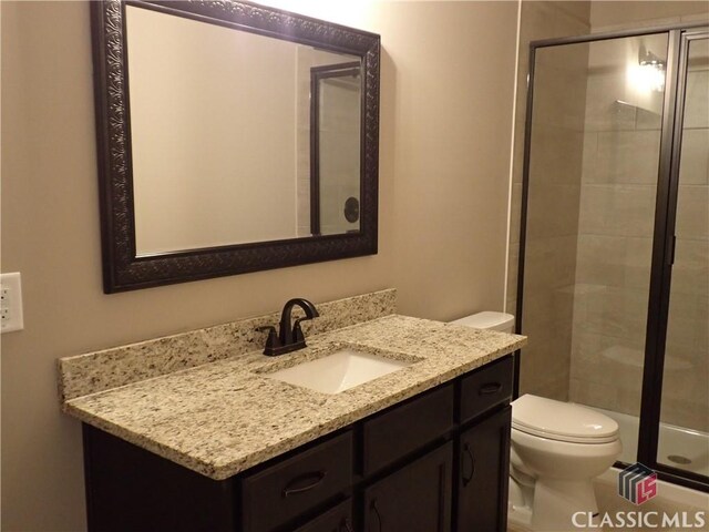 41 Hometown Ct, Jefferson, GA 30549 - full bathroom featuring vanity, a shower stall, and toilet