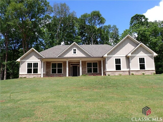 37 Hometown Ct, Jefferson, GA 30549 - view of front of property featuring a front lawn, brick siding, and board and batten siding