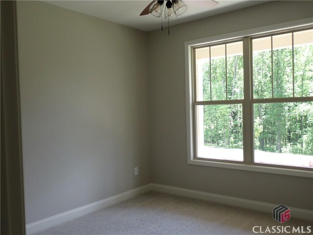 37 Hometown Ct, Jefferson, GA 30549 - spare room with light colored carpet, baseboards, and a ceiling fan