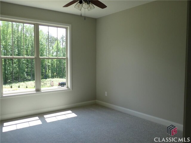 37 Hometown Ct, Jefferson, GA 30549 - carpeted spare room featuring baseboards, ceiling fan, and a healthy amount of sunlight