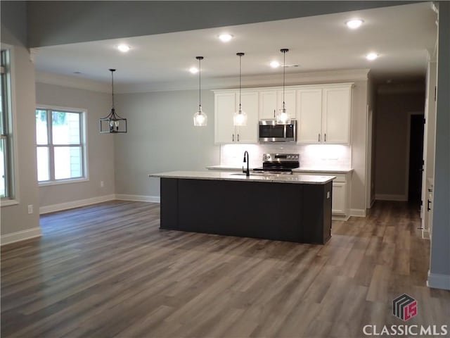 37 Hometown Ct, Jefferson, GA 30549 - kitchen featuring white cabinets, crown molding, appliances with stainless steel finishes, and baseboards