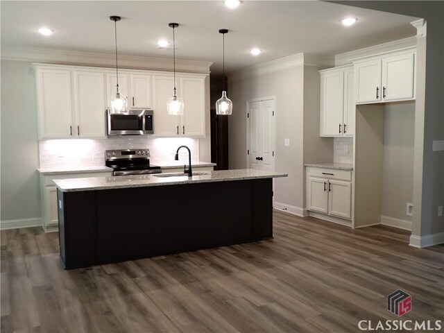 37 Hometown Ct, Jefferson, GA 30549 - kitchen with stainless steel appliances, baseboards, a sink, and white cabinetry