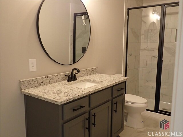 37 Hometown Ct, Jefferson, GA 30549 - bathroom with vanity, marble finish floor, a stall shower, and toilet