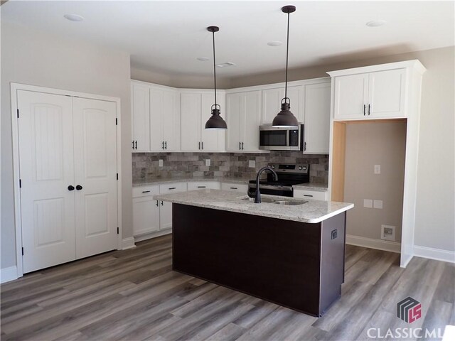 280 Camden Loop, Jefferson, GA 30549 - kitchen featuring wood finished floors, stainless steel appliances, white cabinets, backsplash, and a sink