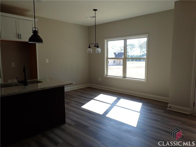 280 Camden Loop, Jefferson, GA 30549 - unfurnished dining area with dark wood-style floors, visible vents, baseboards, and a sink