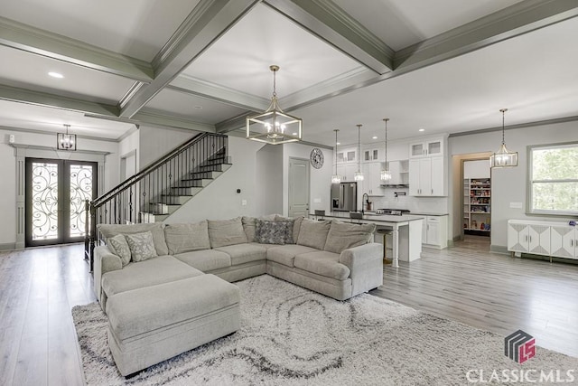 4208 Sierra Creek Ct, Hoschton, GA 30548 - living area featuring ornamental molding, light wood-style flooring, french doors, beamed ceiling, and stairs