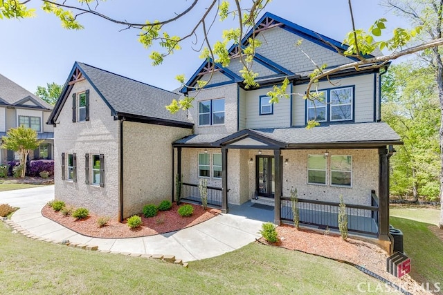 4208 Sierra Creek Ct, Hoschton, GA 30548 - view of front of property with a porch, a front yard, and roof with shingles
