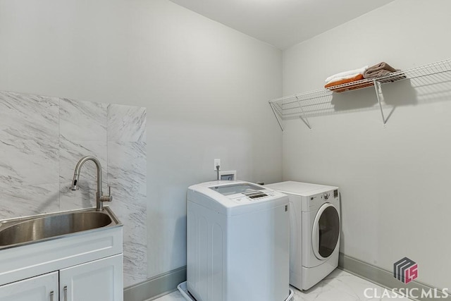 4208 Sierra Creek Ct, Hoschton, GA 30548 - laundry room featuring light marble finish flooring, independent washer and dryer, cabinet space, and baseboards