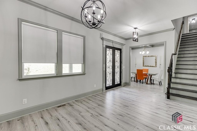 4208 Sierra Creek Ct, Hoschton, GA 30548 - entrance foyer featuring a chandelier, stairs, wood finished floors, ornamental molding, and baseboards