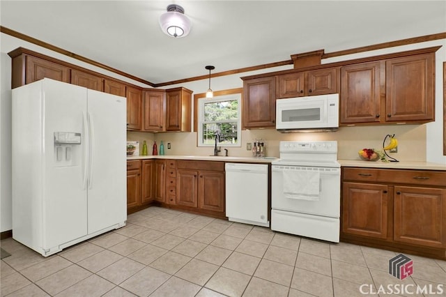 kitchen with light countertops, brown cabinetry, and white appliances