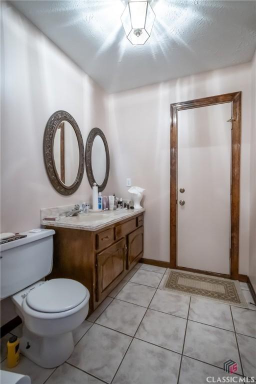 749 Diamond Hill Colbert Rd, Colbert, GA 30628 - bathroom with toilet, tile patterned flooring, and vanity