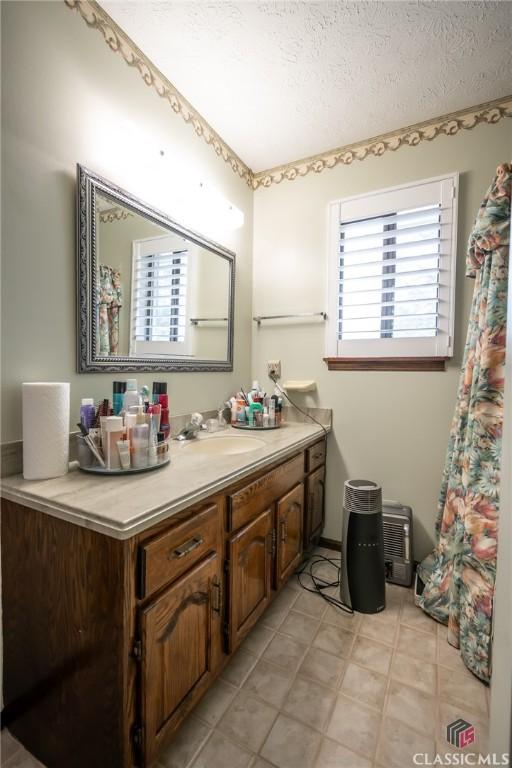 749 Diamond Hill Colbert Rd, Colbert, GA 30628 - bathroom featuring a textured ceiling and vanity
