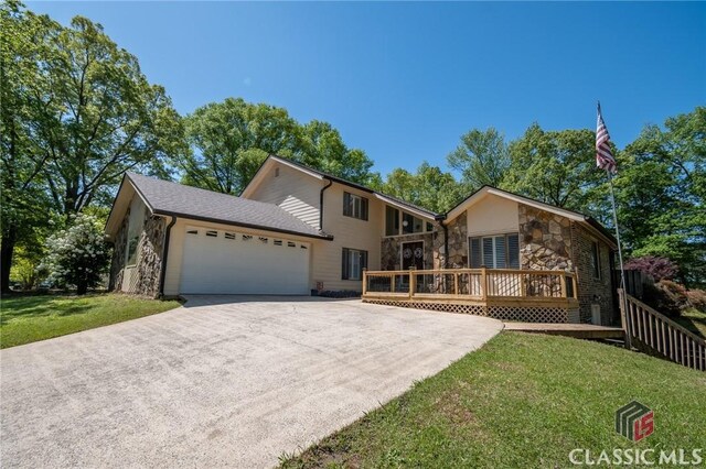 749 Diamond Hill Colbert Rd, Colbert, GA 30628 - view of front of property with a front lawn, a wooden deck, driveway, stone siding, and an attached garage
