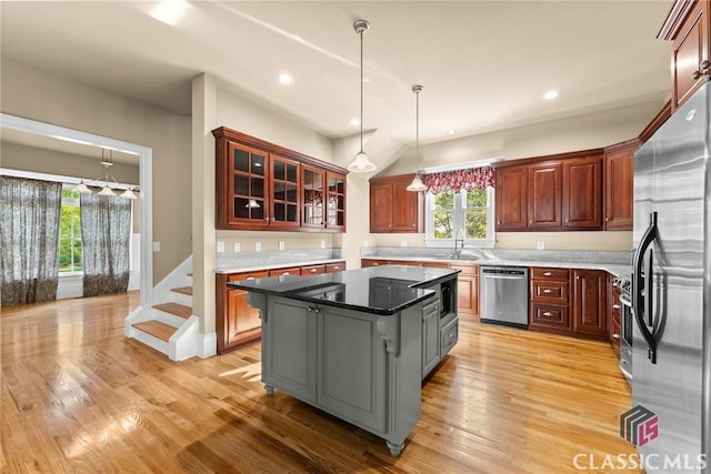 147 Rapids Dr, Bogart, GA 30622 - kitchen featuring appliances with stainless steel finishes, a center island, light wood-type flooring, and a sink