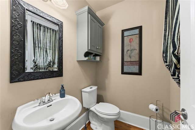 147 Rapids Dr, Bogart, GA 30622 - bathroom with toilet, a sink, wood finished floors, and baseboards