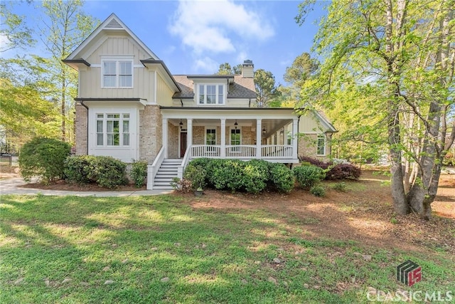 147 Rapids Dr, Bogart, GA 30622 - craftsman inspired home featuring a porch, a front lawn, a chimney, board and batten siding, and brick siding