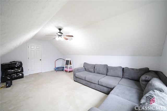 living area with carpet, ceiling fan, vaulted ceiling, and baseboards