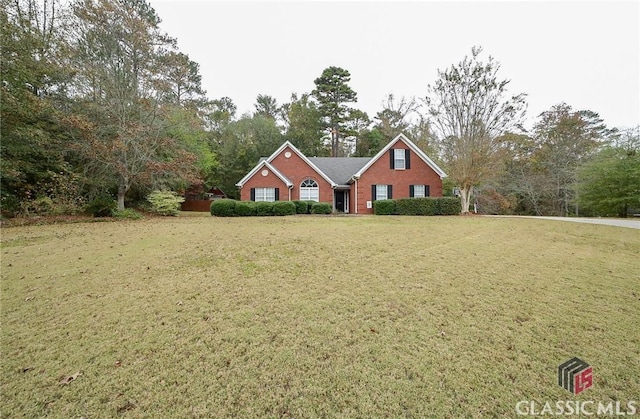 traditional home with a front yard and brick siding