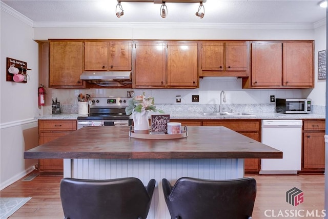 132 Tamara Ct, Athens, GA 30606 - kitchen with brown cabinets, a sink, appliances with stainless steel finishes, and under cabinet range hood