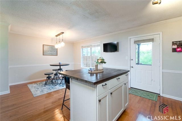 132 Tamara Ct, Athens, GA 30606 - kitchen featuring butcher block counters, wood finished floors, plenty of natural light, and crown molding