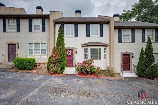 132 Tamara Ct, Athens, GA 30606 - view of property with stucco siding, a chimney, and uncovered parking