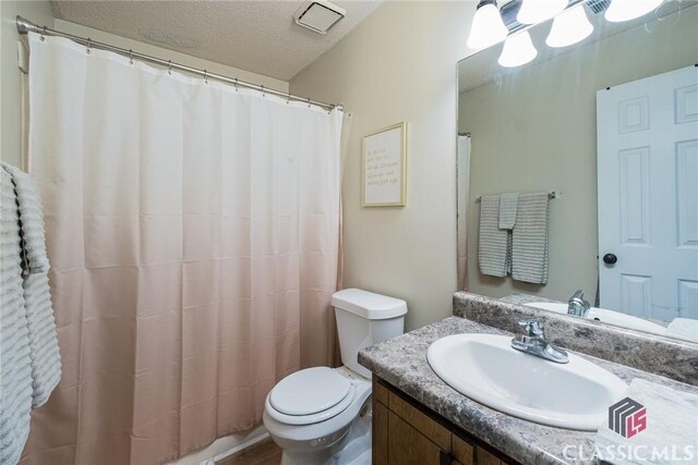 132 Tamara Ct, Athens, GA 30606 - full bathroom featuring toilet, a textured ceiling, and vanity