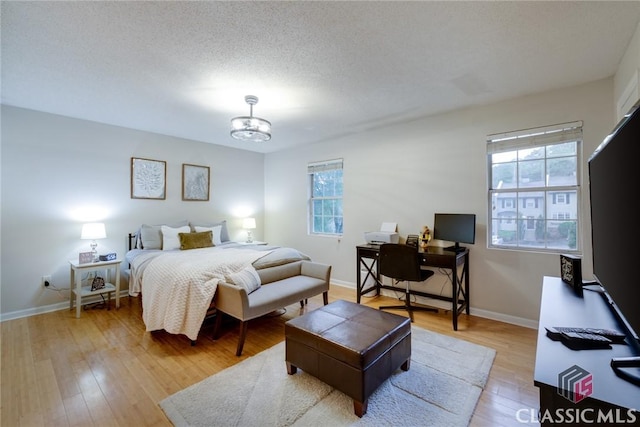 132 Tamara Ct, Athens, GA 30606 - bedroom with an inviting chandelier, wood finished floors, and baseboards