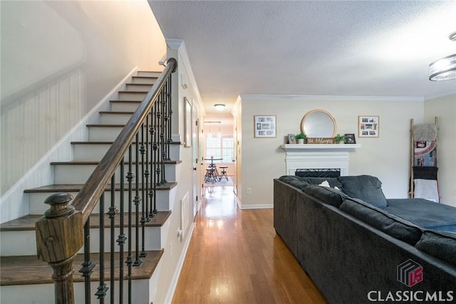 132 Tamara Ct, Athens, GA 30606 - living room with wood finished floors, stairs, crown molding, and a fireplace