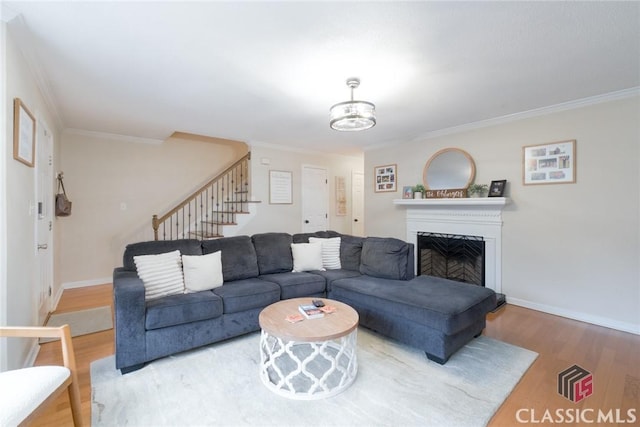 132 Tamara Ct, Athens, GA 30606 - living room featuring crown molding, stairway, baseboards, a fireplace, and wood finished floors