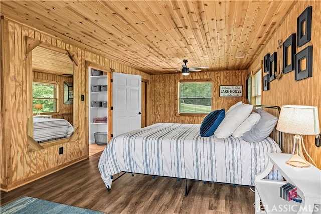 bedroom with wood walls, wooden ceiling, and wood finished floors