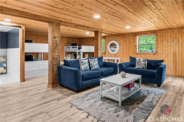 living room with wood walls, wood ceiling, and light wood finished floors
