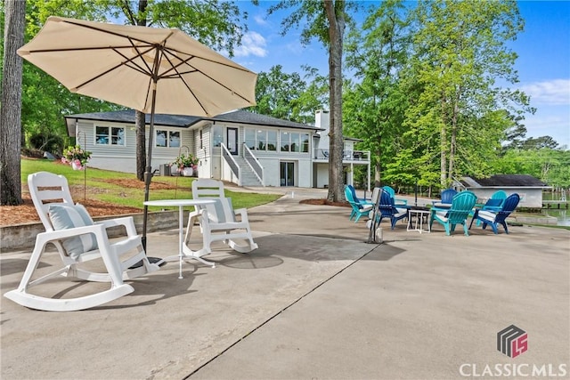 view of patio / terrace with an outdoor fire pit and stairway