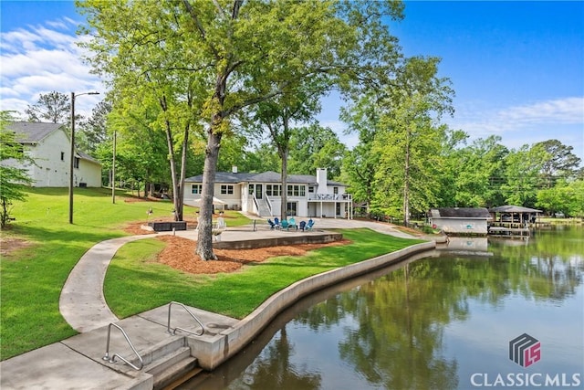 exterior space featuring a water view and a yard