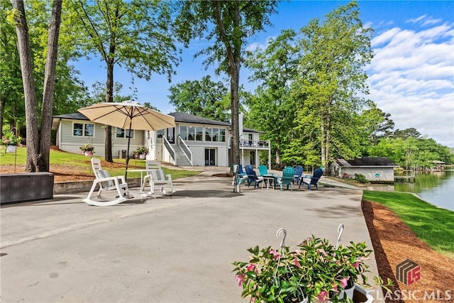 view of community featuring a patio and stairway