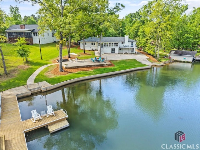 dock area with a yard, a water view, and a patio