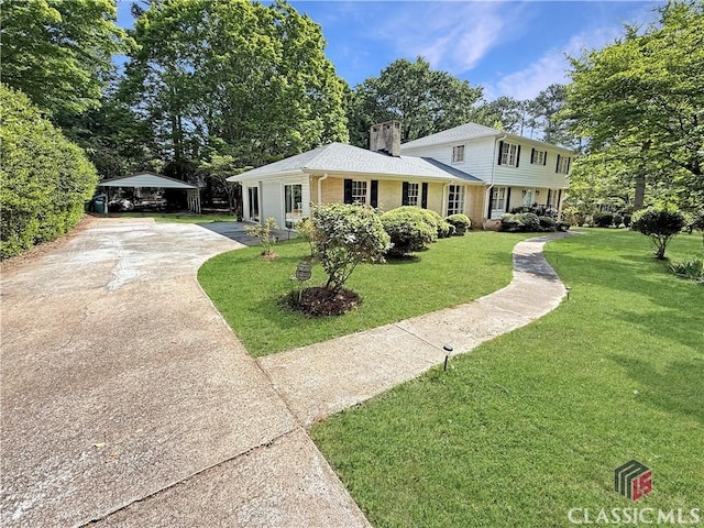 155 Broomsedge Trl, Athens, GA 30605 - view of front facade with driveway, a chimney, a front yard, and a carport