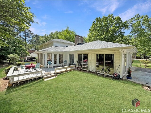 155 Broomsedge Trl, Athens, GA 30605 - rear view of house featuring a lawn, a wooden deck, a shingled roof, and a chimney
