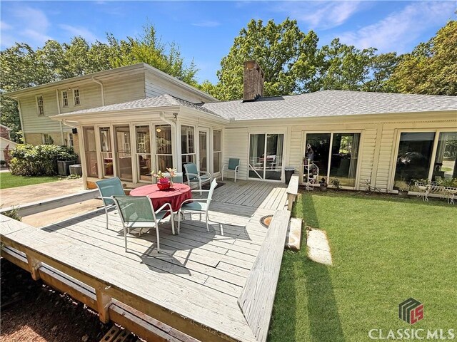 155 Broomsedge Trl, Athens, GA 30605 - back of house with a chimney, a wooden deck, a sunroom, a yard, and a shingled roof
