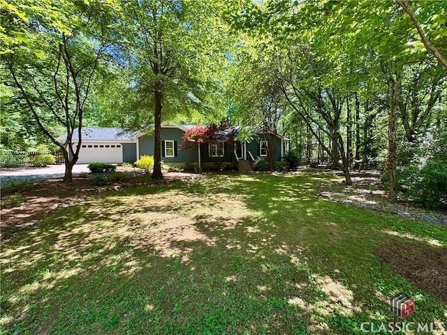 single story home with an attached garage, driveway, and a front yard