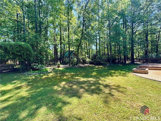 view of yard featuring fence and an outdoor structure