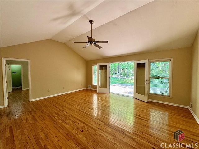 interior space with baseboards, ceiling fan, hardwood / wood-style floors, and lofted ceiling