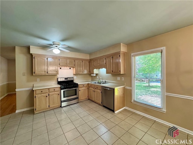 kitchen with a ceiling fan, a sink, appliances with stainless steel finishes, and light countertops