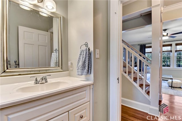 bathroom featuring vanity, ceiling fan, and wood finished floors