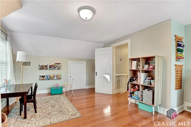 playroom with baseboards, visible vents, and wood finished floors