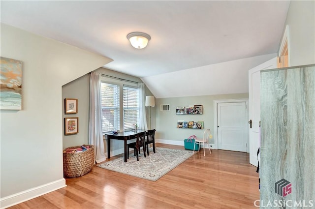 home office with visible vents, light wood-style flooring, and baseboards