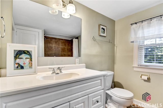 full bathroom with vanity and toilet