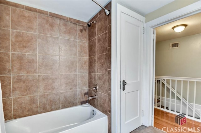 full bath featuring visible vents and tub / shower combination
