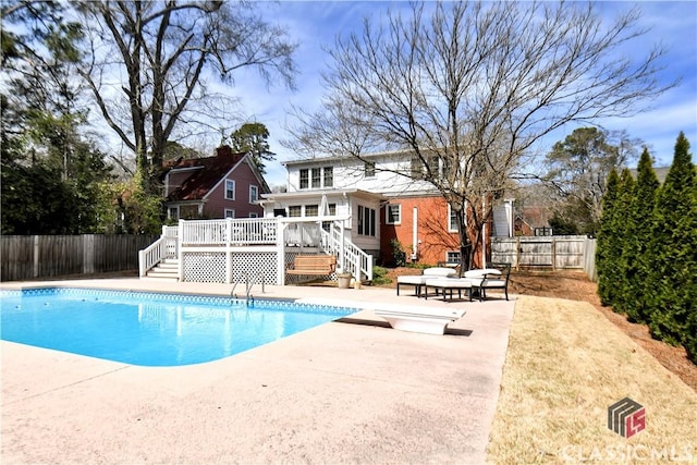 view of swimming pool featuring a deck, a patio, a fenced backyard, stairs, and a fenced in pool