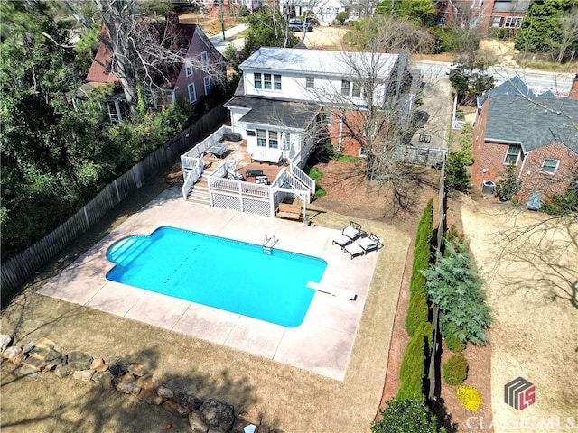 view of pool featuring a deck, a patio, a fenced backyard, a fenced in pool, and stairs